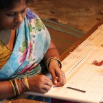 A woman prepares for the preliminary tie-and-dye process